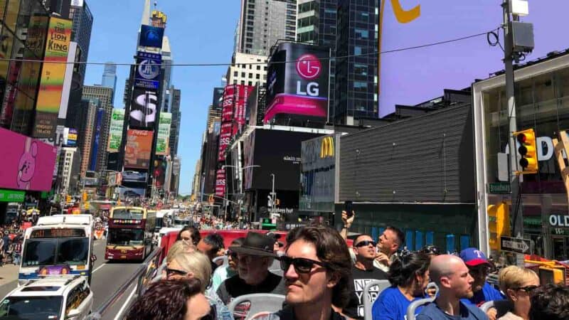 hop on hop off bus in NYC in Times Square a good way to travel NYC on a budget