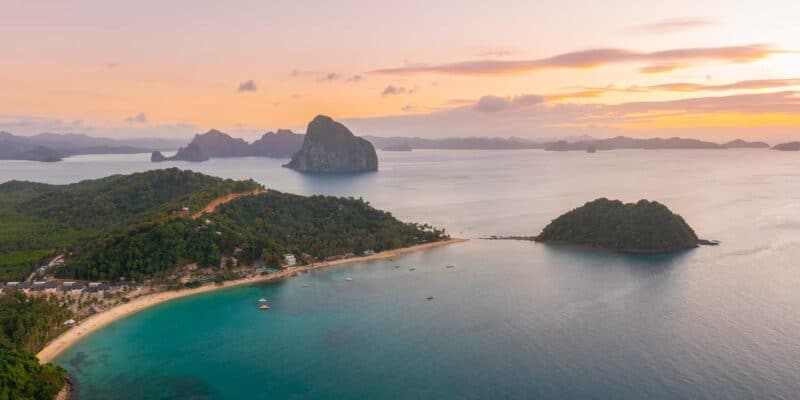 Pink and Orange sunset of Las Cabanas Beach near El Nido Town on Palawan Island