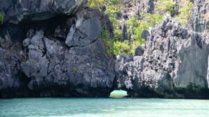 rock wall with hole in it known as Secret Beach in El Nido Palawan - Top Attractions