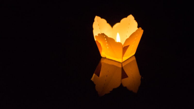 A single yellow lantern floats down the river during the Hoi An Lantern Festival