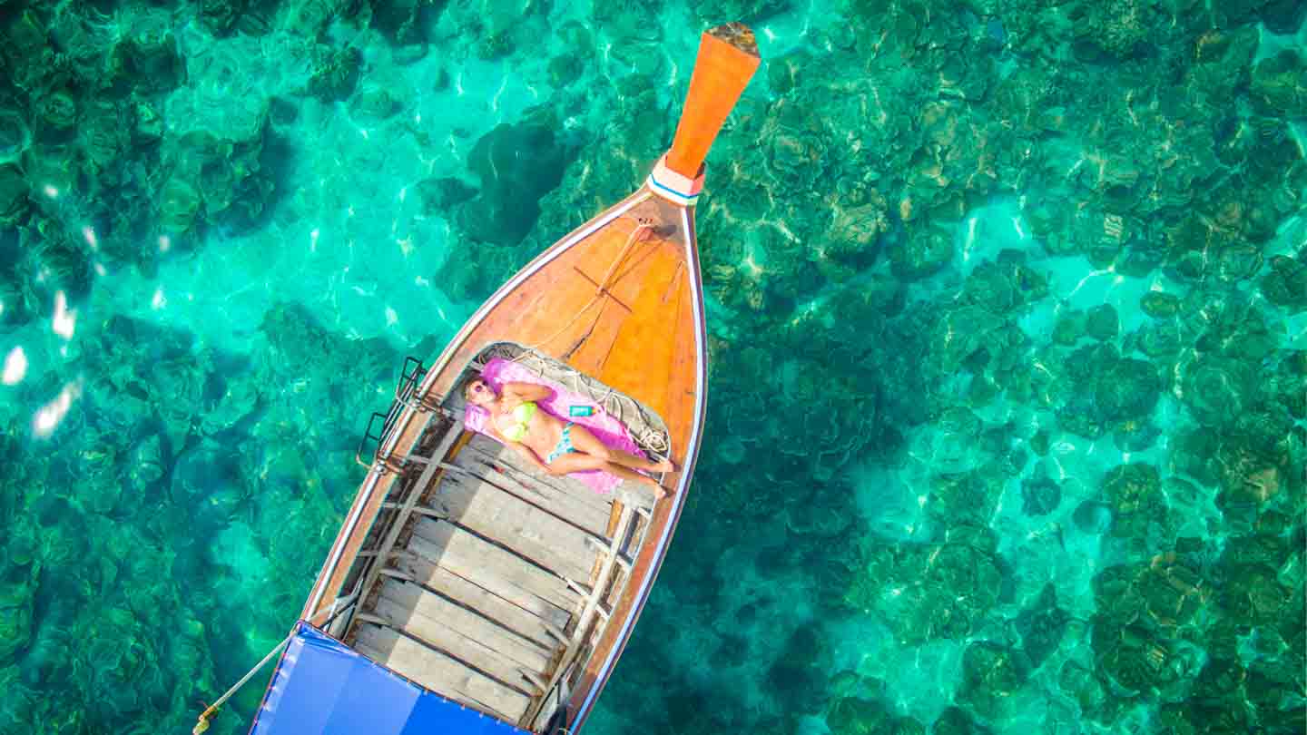 Woman in a long tail boat during a Koh Lipe Day Trip
