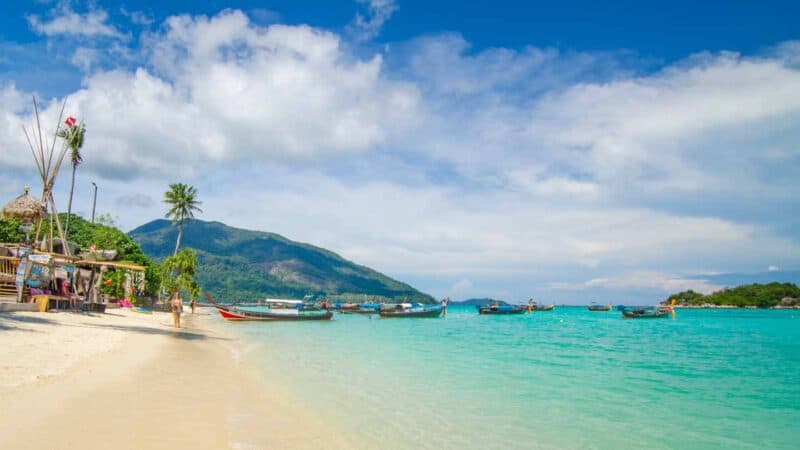 person walking on Sunrise Beach in Koh Lipe