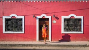 Day trips from Playa del Carmen head to Valladolid Red building with a woman standing