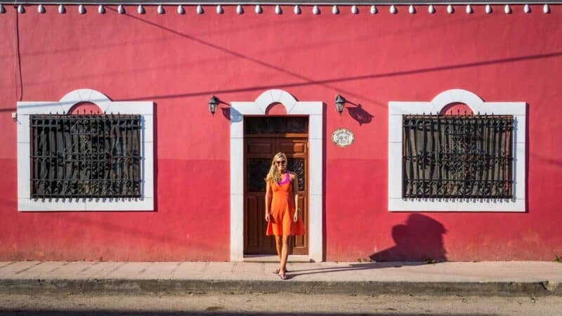 Day trips from Playa del Carmen head to Valladolid Red building with a woman standing