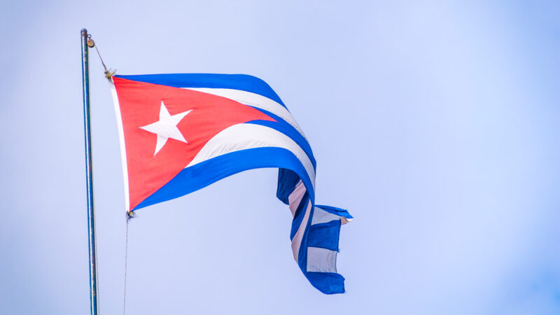 Cuban flag blowing in the wind over Havana