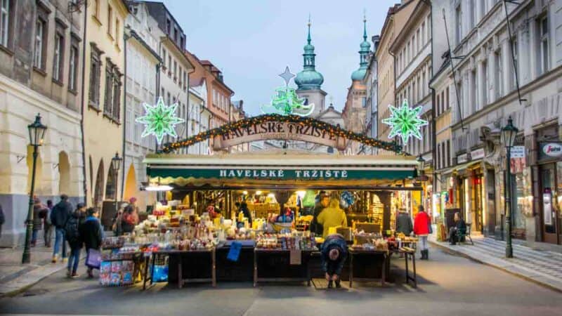 View of a Christmas Market in Prague decorated for the holidays with green lights and Christmas ornaments - things to do in Prague 