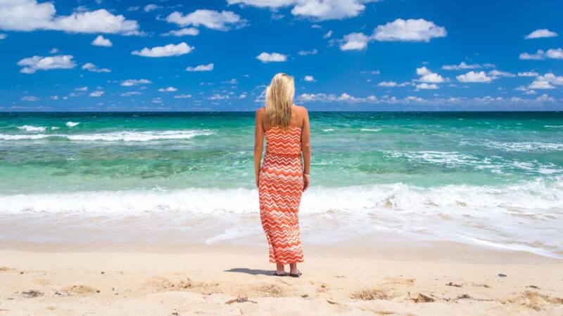 Woman in an orange dress on Playa Jibacoa Cuba