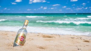 Bottle of Cuba's club Havana propped up in the sands of Playa Jibacoa