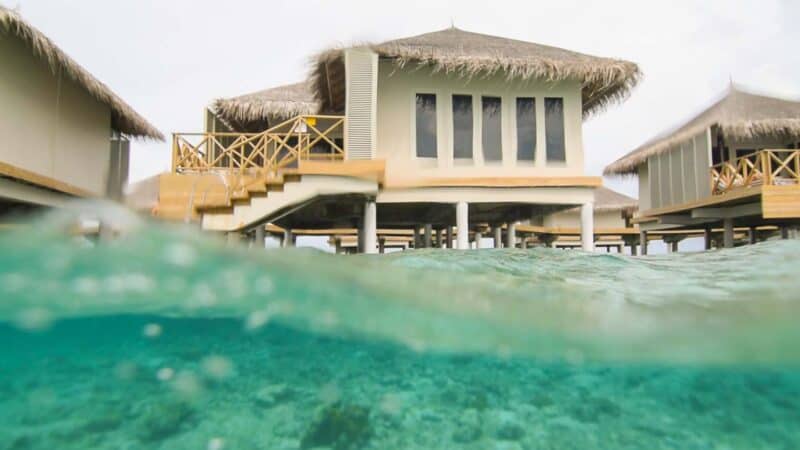 over under gopro dome photo of the overwater bungalows at Cinnamon Dhonveli Maldives