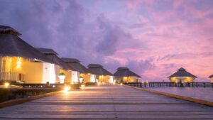 dock to water villas at Ellaidhoo Maldives by Cinnamon during a pink sunset