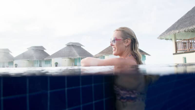 woman in the infinity pool of Ellaidhoo Maldives by Cinnamon