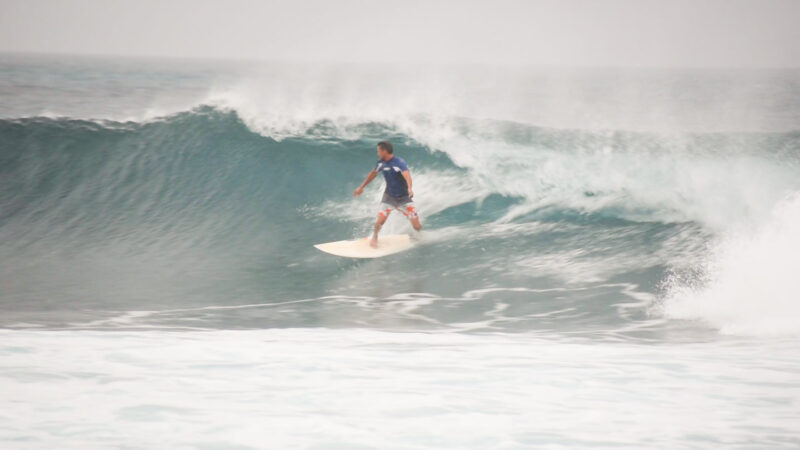 man surfing a medium sized wave at Cinnamon Dhonveli Maldives