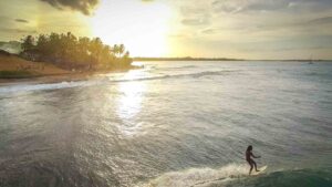 Surfers at sunset in arugam bay - Best of Sri Lanka
