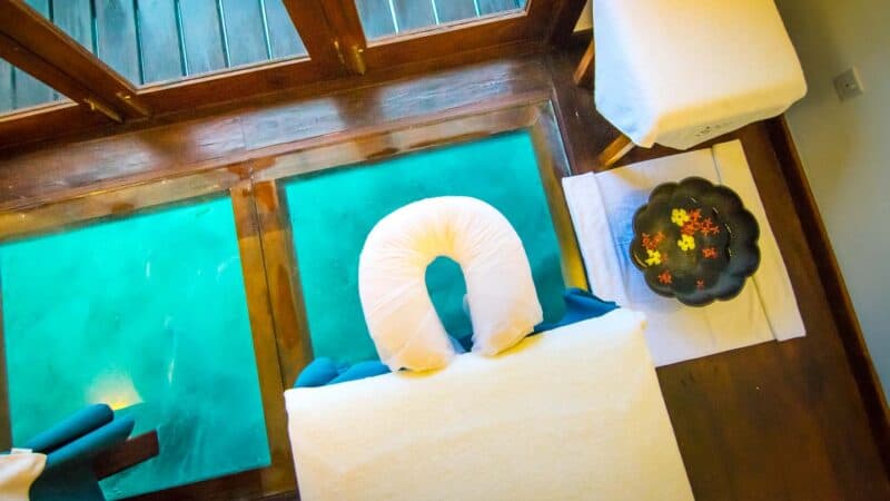 Spa with glass floor looking down into the ocean at Summer Island Maldives