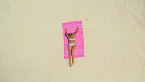 girl laying on a beach blanket on the beach in the Maldives