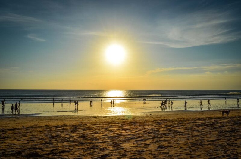 Kuta Beach at sunset people playing football