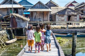 Baja children on the dock in Wakatobi Indonesia