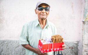 Old Cuban man selling Cuban cigars