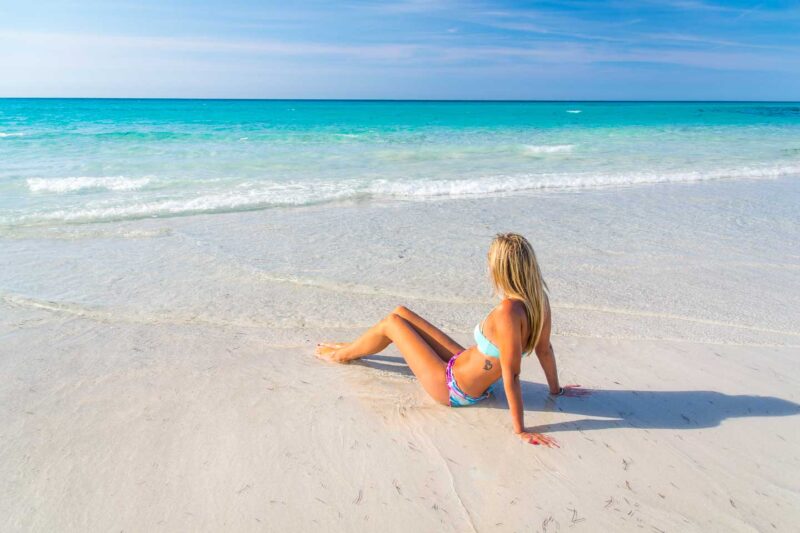 girl relaxing on the white sandy beach of Varadero Cuba one of the best places in Cuba