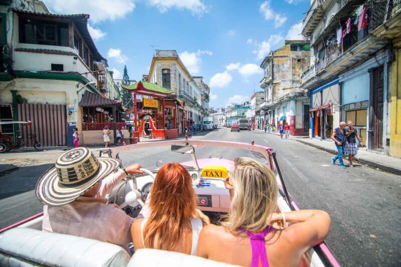 riding in a classic car on an Havana city tour