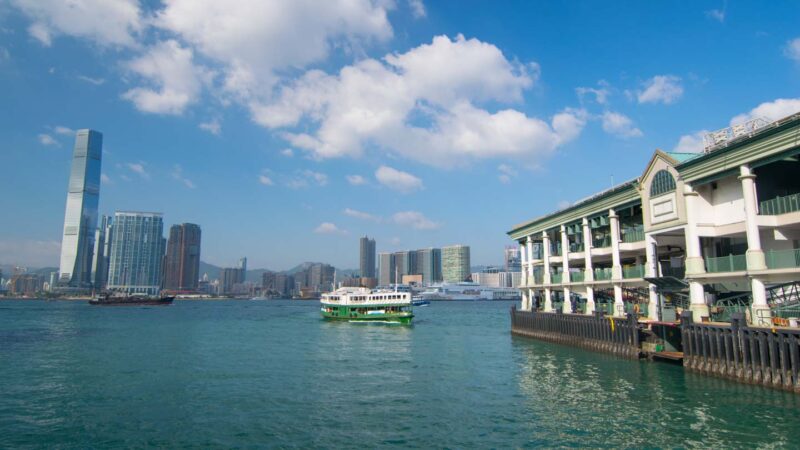 The green and white star ferry in Victoria Harbour in Hong Kong looking at the Kowloon side of HK