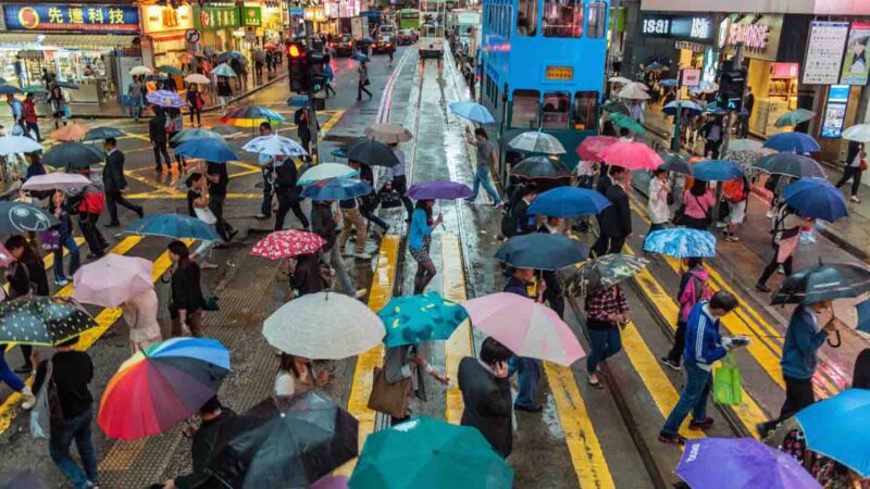People holding umbrellas on a rainy Hong Kong street