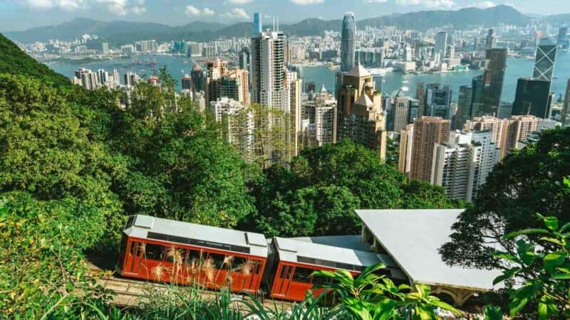 Victoria Peak Tram going up and the Hong Kong skyline in the background