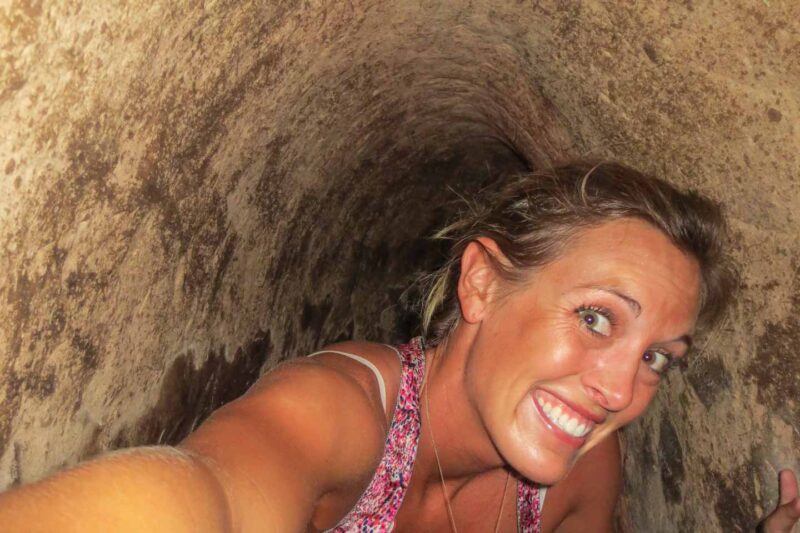 Girl crawling through the Cu Chi tunnels in Vietnam used during Vietnam War