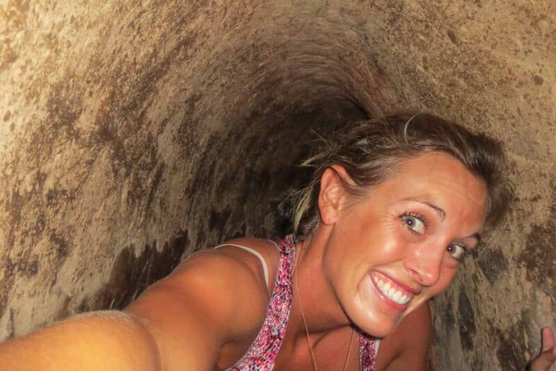 Girl crawling through the Cu Chi tunnels in Vietnam used during Vietnam War