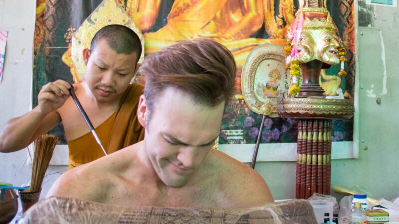 Adam getting Sak Yant Tattoo pain face