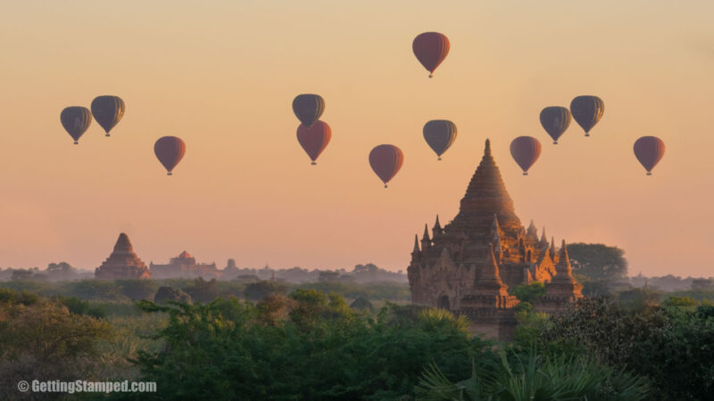Hot air balloons pass over a temple in Bagan Myanmar