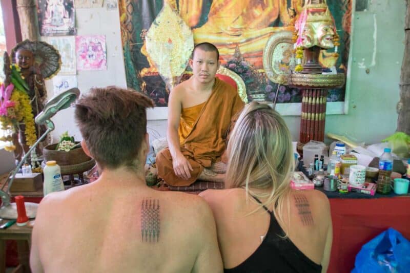 Hannah and Adam Face the tattoo ajarn after receiving their Sak Yant tattoos