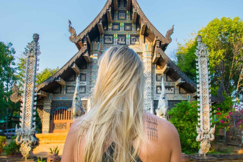 Hannah standing in front of a temple in Chiang Mai with her new Sak Yant Tattoo