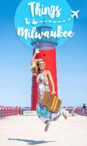 woman jumping in front of red light house - things to do in milwaukee