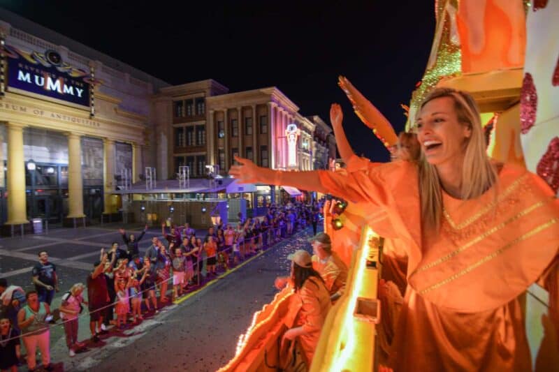 Girl throwing beads at the Universal Orlando Mardi Gras Parade