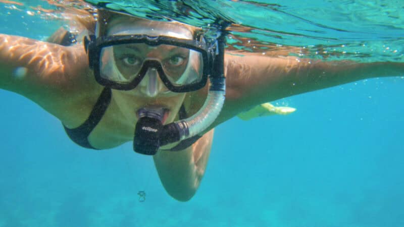 woman snorkeling off of the beach in Belize