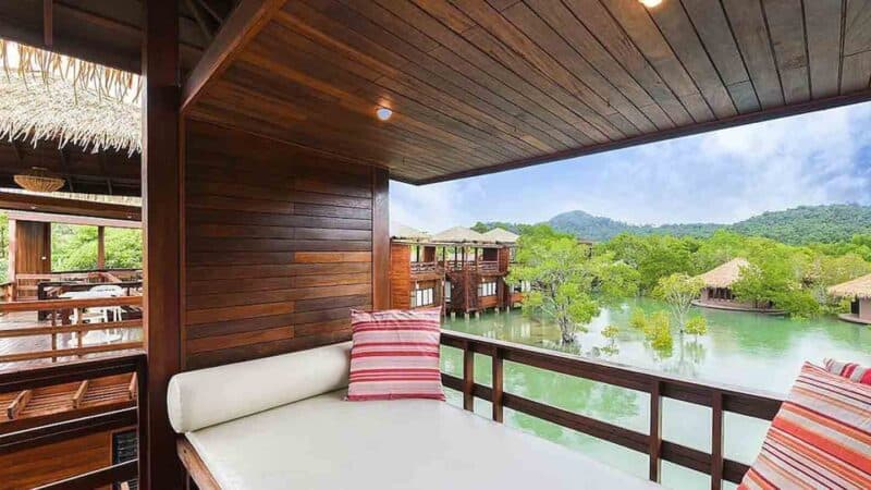 Outdoor seating area over the water at Blue Sky Koh Phayam Hotel