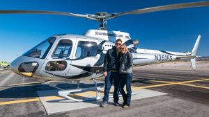 a couple stands in front of a Cheapest Grand Canyon Helicopter
