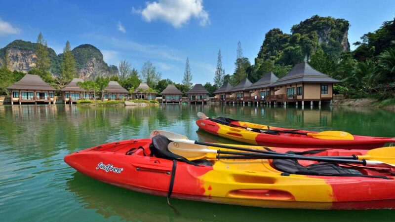 kayaks in the water by the overwater bungalows in Thailand at Poonsiri Resort Aonang
