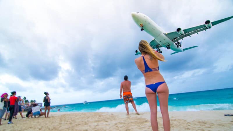 woman standing on the beach at SMX airport - on the way to Anguilla