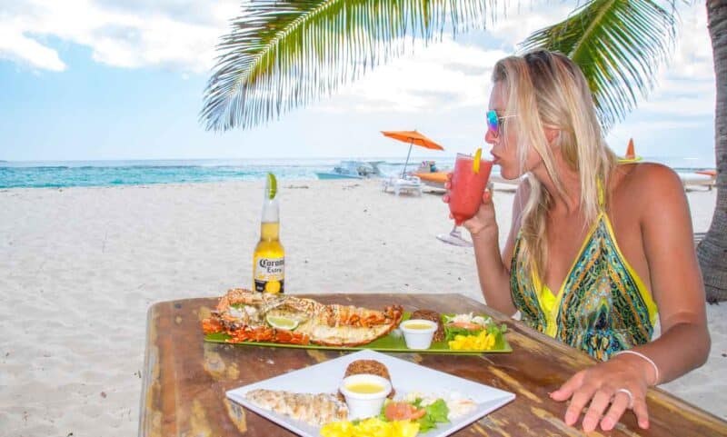 Hannah eating a lobster lunch at the Sandy Island restaurant in Anguilla