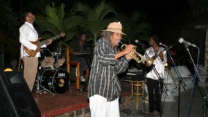 Man playing a trumpet in a reggae band in Negril