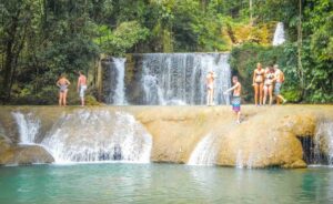 People standing on YS falls which is one of the best things to do in Negril