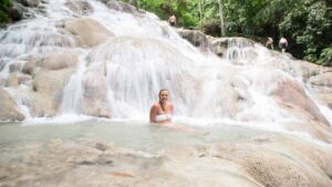 Woman sitting in one of the many pools of Dunns River Falls