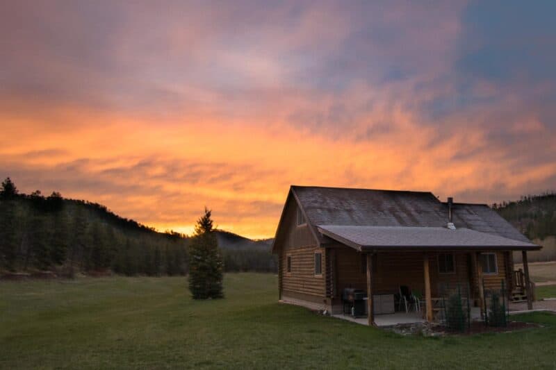 Log cabin at sunrise on a south dakota road trip