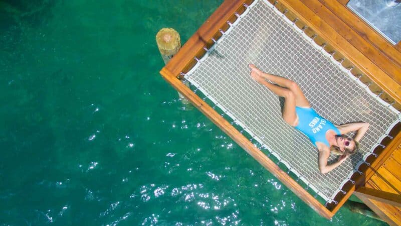 woman in a hammock at Sandals Grande St Lucian - Overwater bungalows Caribbean