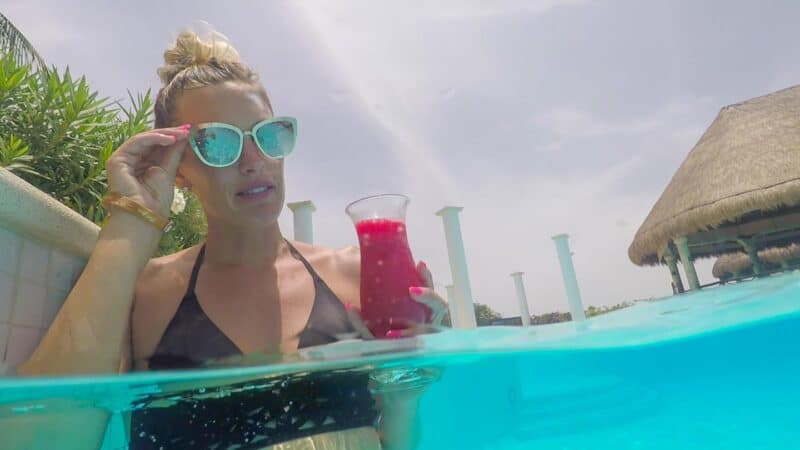 Woman with a red drink at the seim up bar of he Grand Palladium Riviera Maya