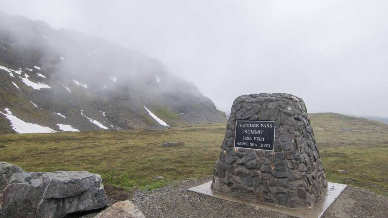 Stone Sign Post at the top of Hatcher Pass with elevation of 3886 ft above sea level