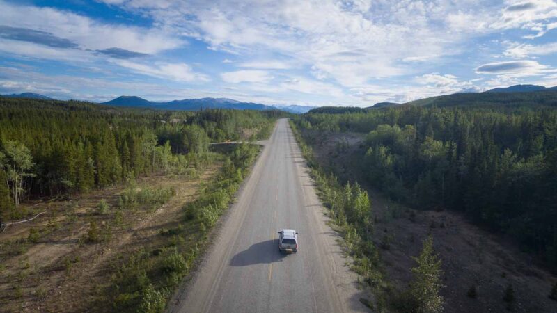Single car on the road to Alaska showing the road condtitons on the Alcan Highway