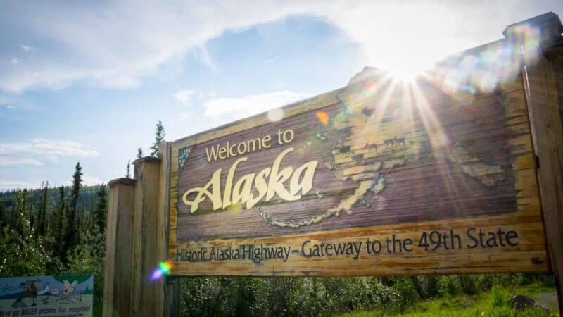 Star burst photo of the Sign post at the border of Alaska and Canada while driving to Alaska